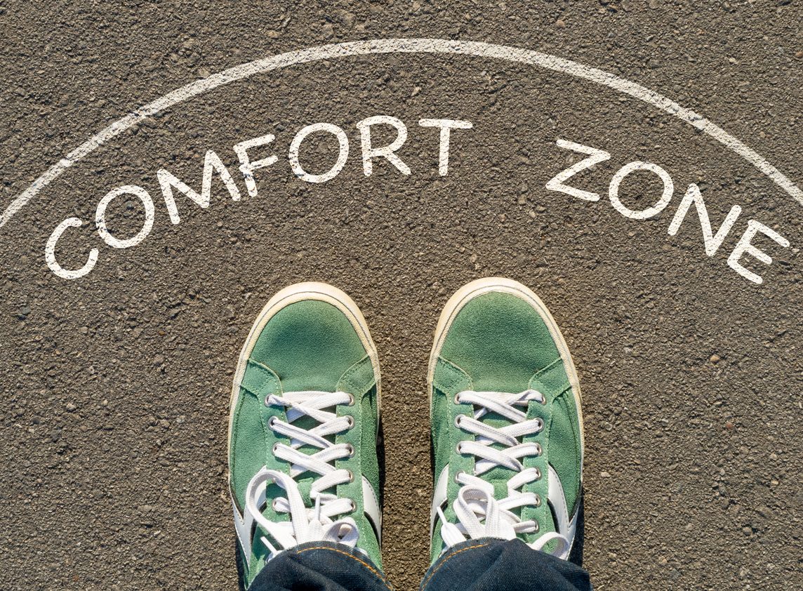 photo on top of the sneakers and the inscription comfort zone on the asphalt, the concept of personal private space